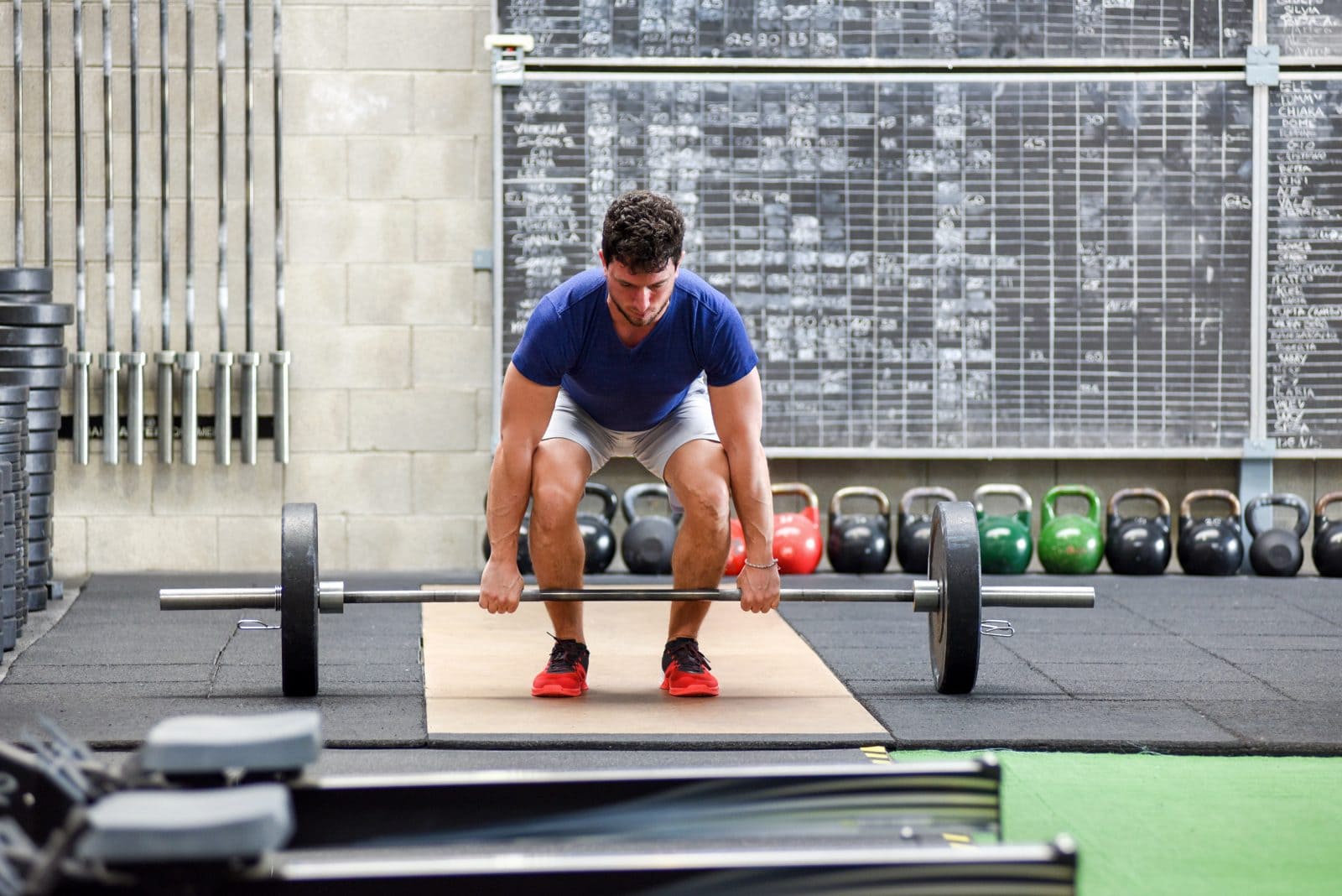 Man beginning deadlift in gym 1073151